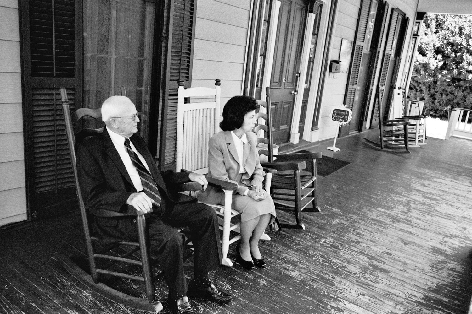 A Southern couple sit on the front porch of the Walnut Hills Restaurant in Vicksburg, Miss.