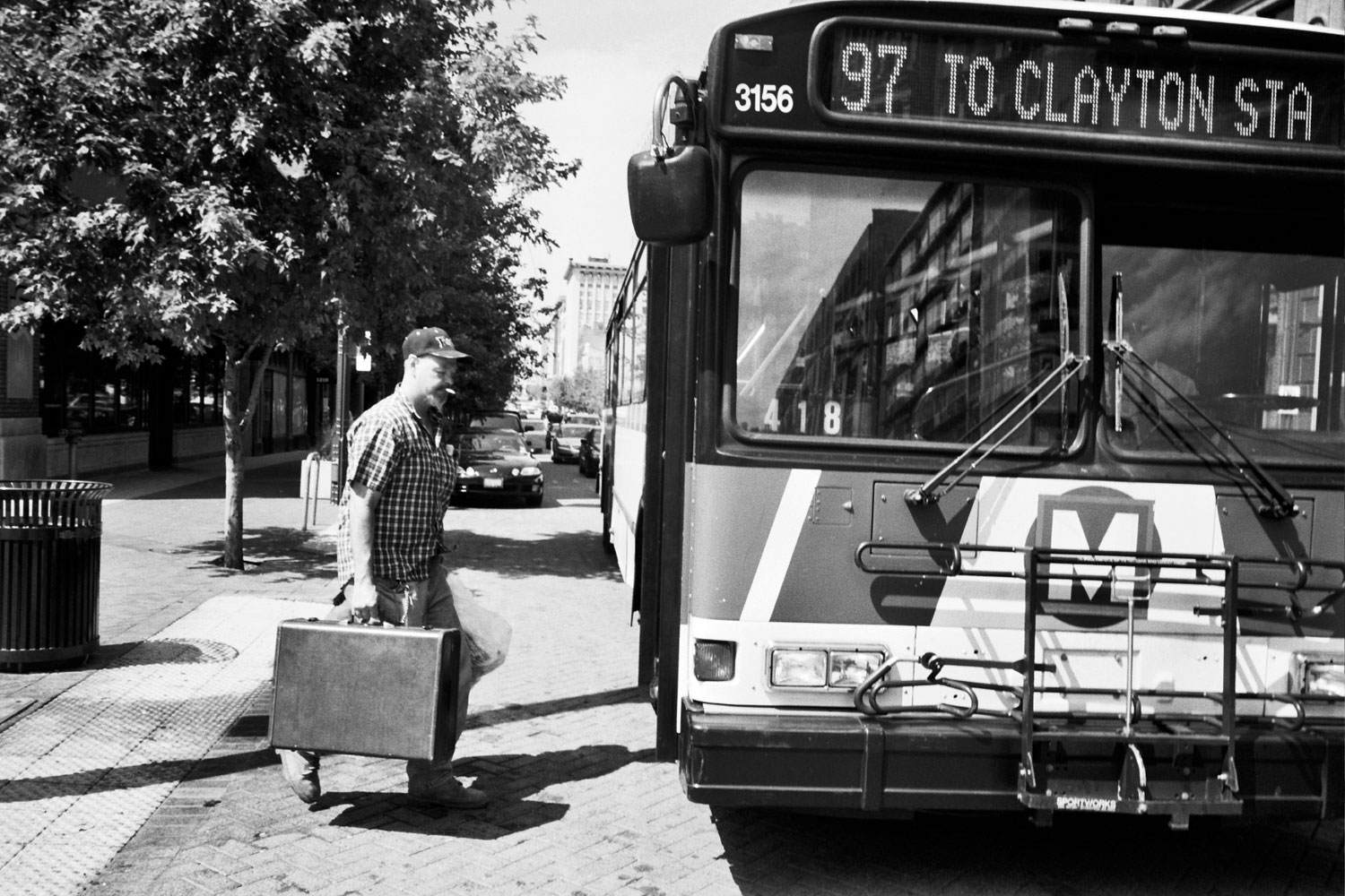 A passenger steps on to a bus heading for Clayton Station in St. Louis, Mo.