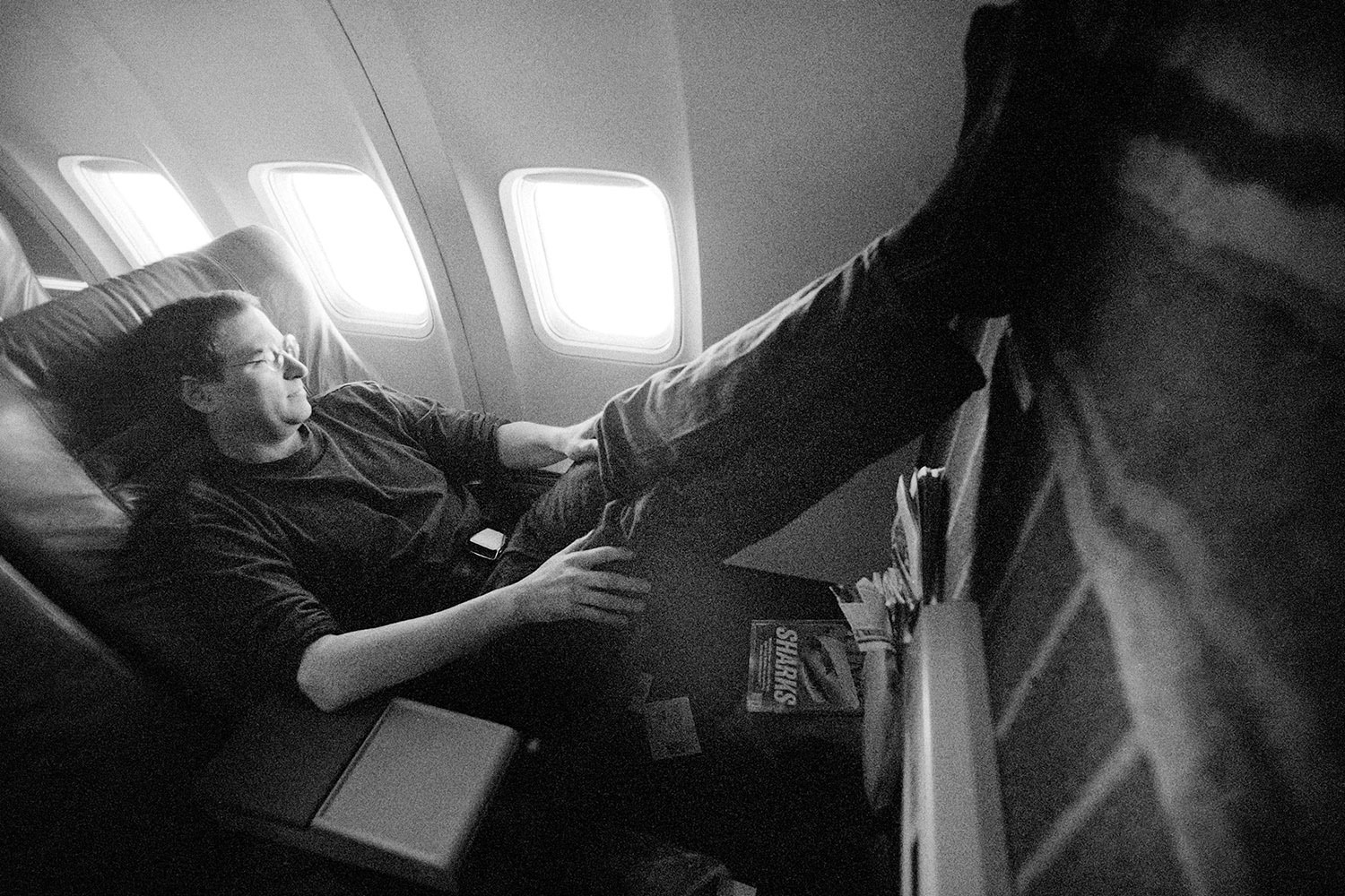 Jobs rests on a flight to the Macworld Expo in Boston in 1997, the year he took back the reins at Apple after a 12-year hiatus.