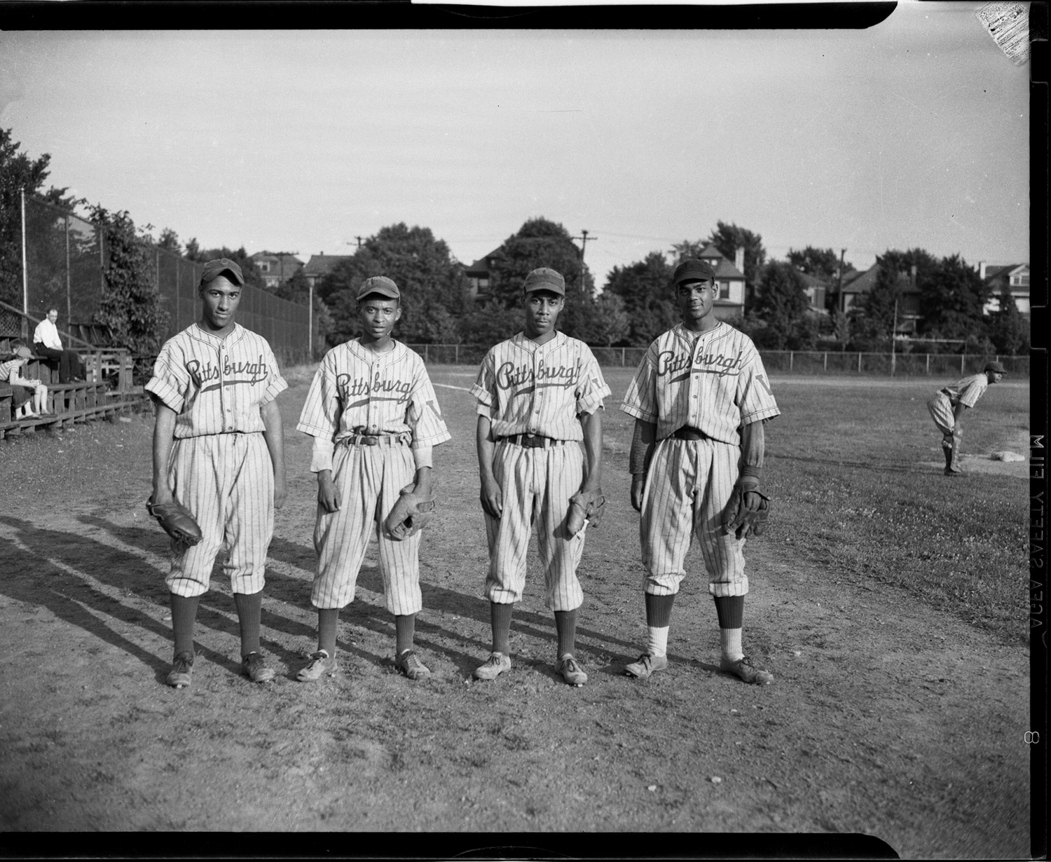 Four Pittsburgh Crawfords baseball players standing on a field, May 1945.