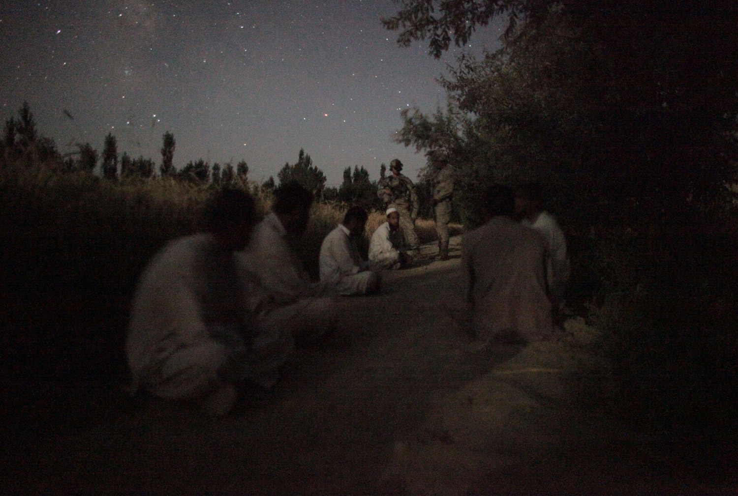 Michael Kamber, July 16, 2009
                               I think many of us took some really terrible photos in Afghanistan: bodies torn up by bombs, ripped apart by bullets. But this photo always disturbed me—placid though it is. We were on a night mission and these American soldiers went door to door pulling men from their beds in front of their screaming children, putting them on the ground in the freezing cold, then marching them off under arrest. Maybe some of the men were insurgents, you almost never know when you're out there. But they were all released the next morning. As we hiked back to base around 5 a.m., the First Sergeant was sort of thinking out loud. 'Boy, we sure didn't make any friends out there tonight,' he said.