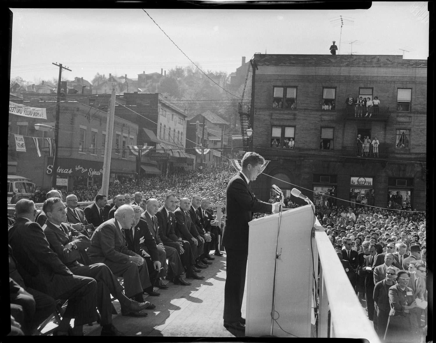 President John F. Kennedy speaking at a podium in Monessen, Pennsylvania, Oct. 13, 1962.