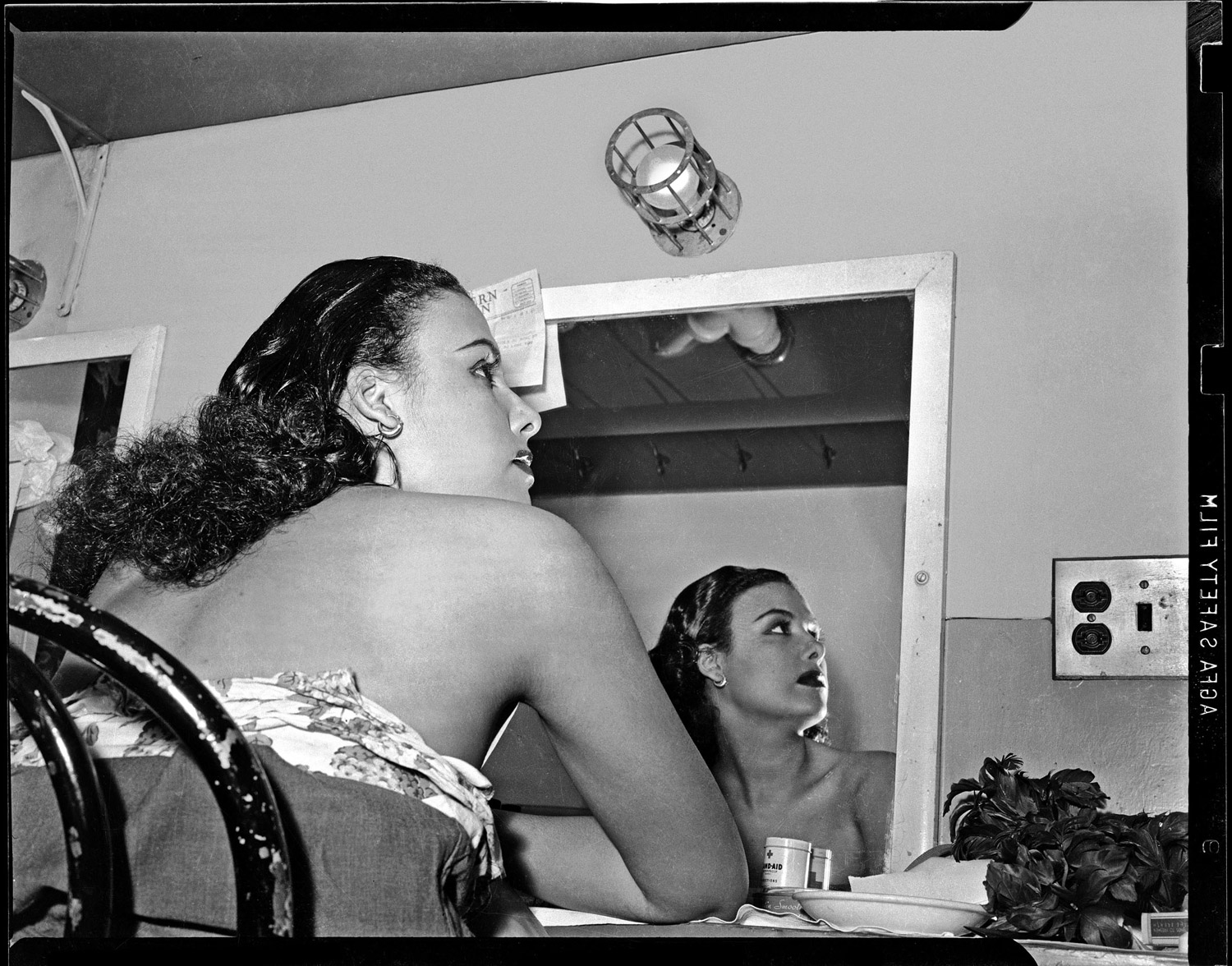 Lena Horne reflected in a mirror in her dressing room at the Stanley Theatre, 1944.