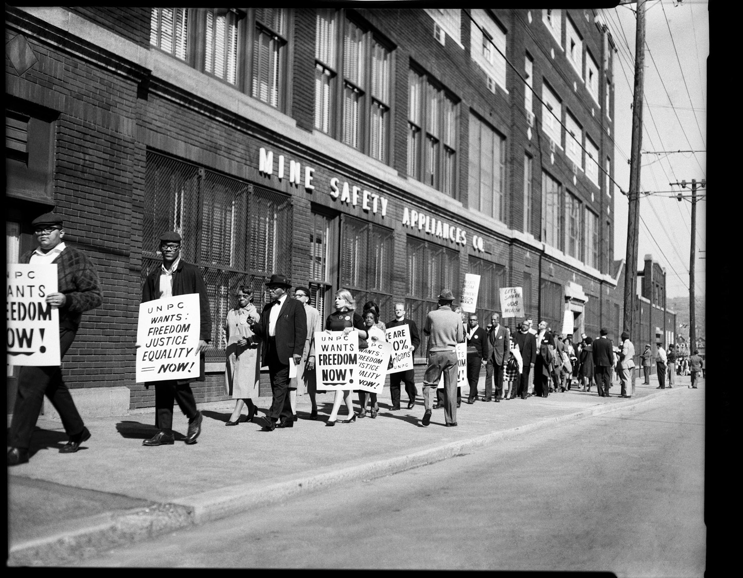 Protestors with UNPC signs outside United Mine Safety Appliance, Braddock Avenue, October 1963.