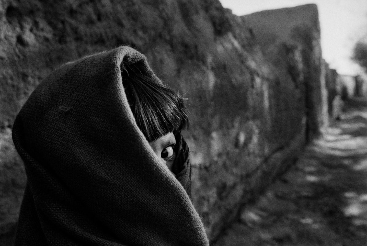 Seamus Murphy, November 2001
                               A young girl soon after dawn in the village of Ghulam Ali on the Shamali Plain. Fighting between the Northern Alliance and the Taliban, along with massive US air strikes, made the plain a critically dangerous place to live.
                              
                              This image—or maybe this girl—always makes me ask: Who are you? Are you still alive? What are you doing now, 10 years later? Do you still live in Afghanistan? Do you still live in your village on the Shamali Plain, north of Kabul? Are you married? Have you ever seen this photograph? Would you let me photograph you now?