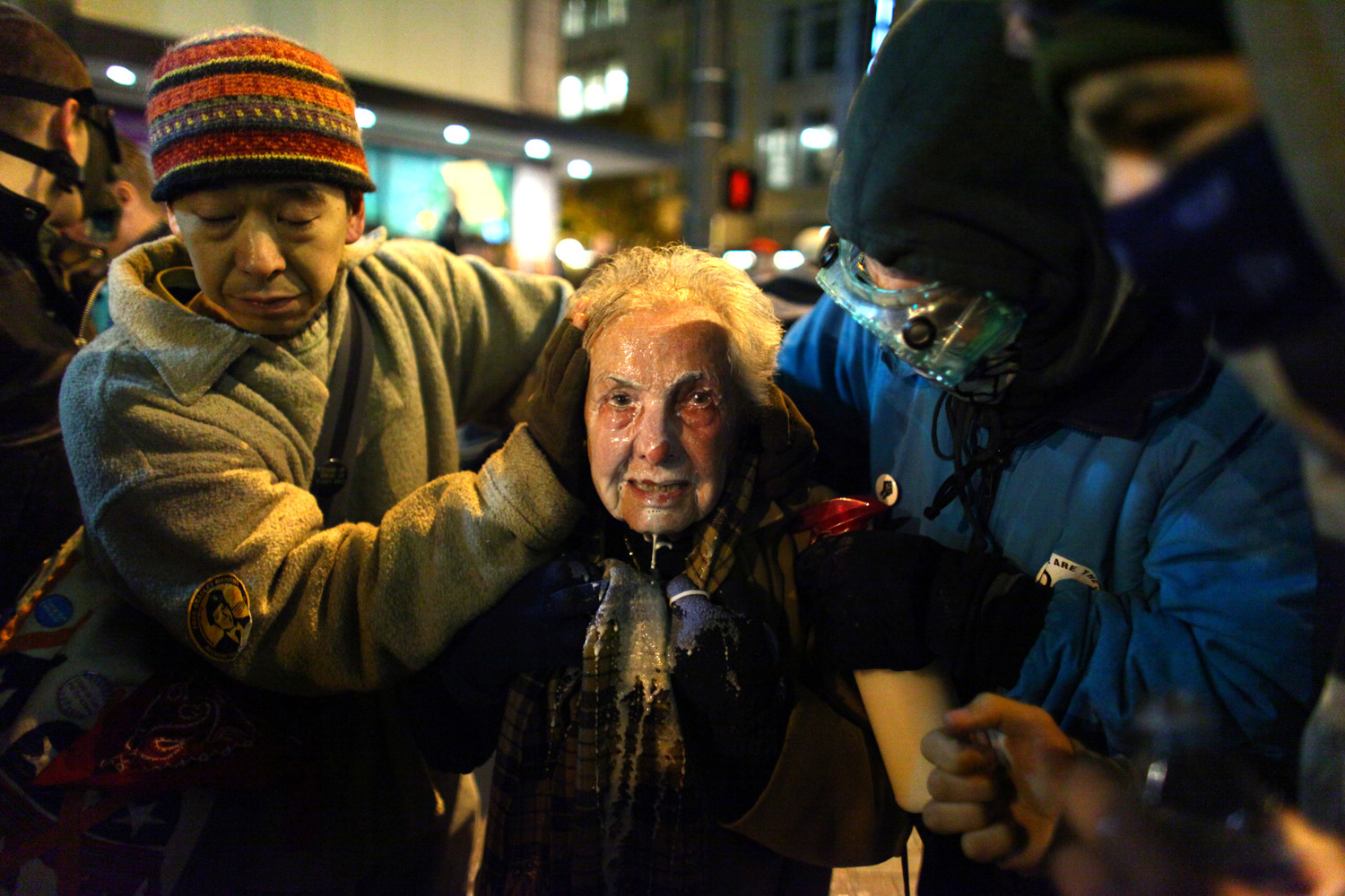 November 15, 2011. Seattle activist Dorli Rainey, 84, reacts after being pepper sprayed by Seattle Police during an Occupy Seattle protest in downtown Seattle. Protesters gathered in the intersection of 5th Avenue and Pine Street after marching from their camp at Seattle Central Community College in support of Occupy Wall Street. Many refused to move from the intersection after being ordered by police. Police then began spraying pepper spray into the gathered crowd hitting dozens of people, some on the sidewalk. A pregnant woman was taken from the melee in an ambulance after being struck with spray.