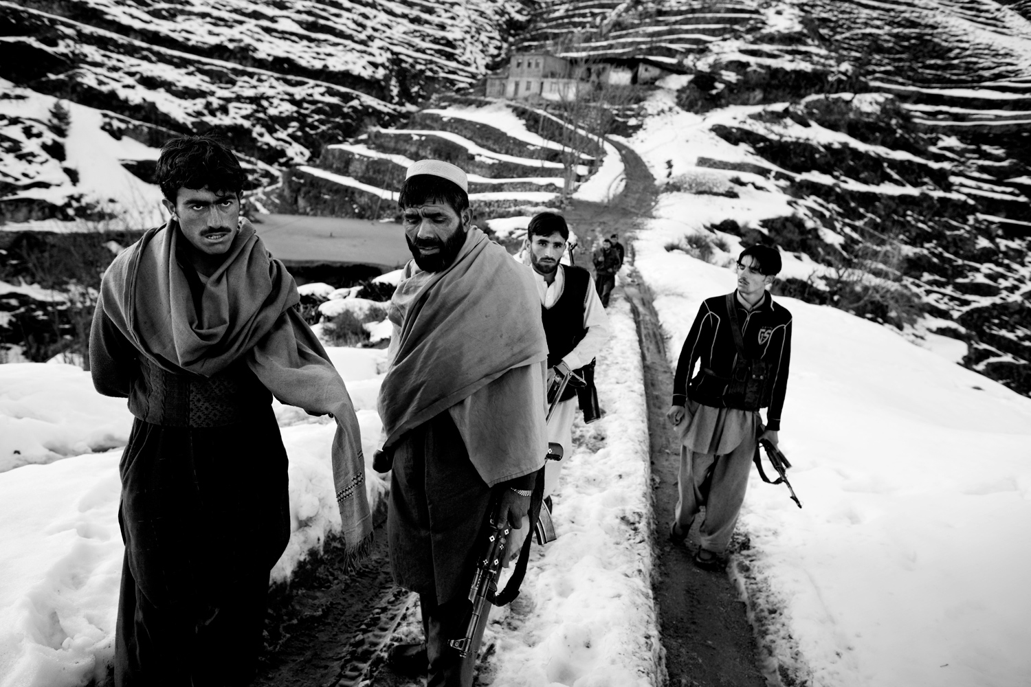 Pakistan, Swat Valley, Mahnbanr (Tehsil Qilagai) near the Dir border, March 2011. Armed Lashkar members performing pehra on a snow-covered road that leads to the populated area of Mahnbanr in Qilagai Teshil. Communication gaps due to the bad condition of the road isolate the Lashkars during winter, making their task of defending the area more difficult.
