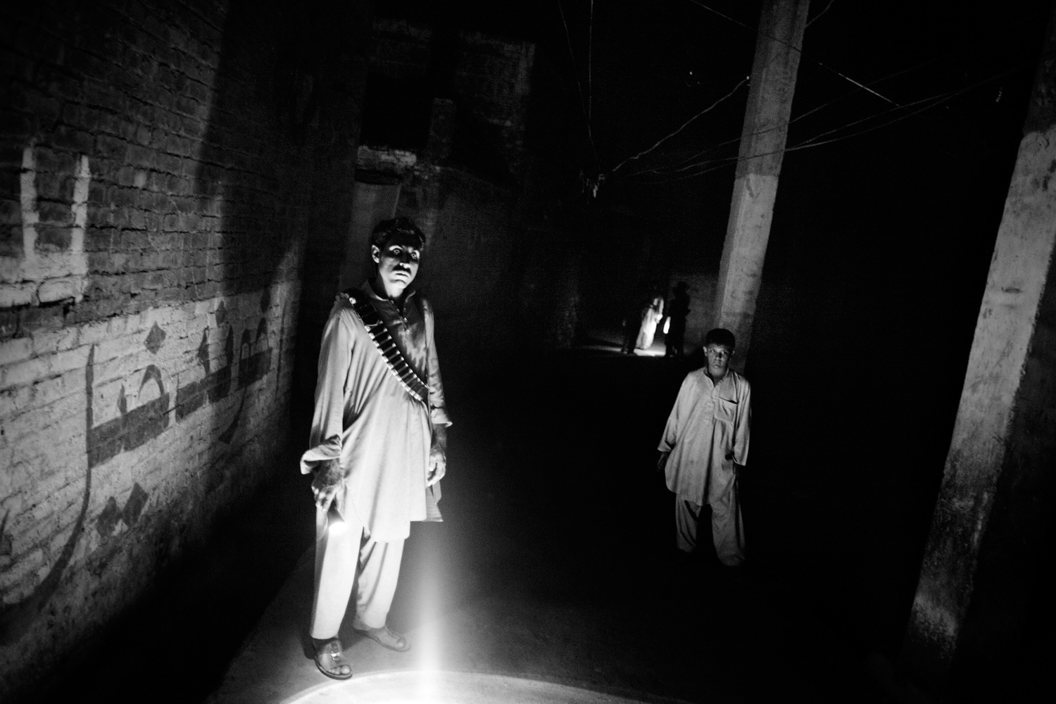 Pakistan, Swat Valley, Bara Bandai, November 2010. Lashkar members, under the leadership of Idrees Lala, performing pehra on the streets of the village. A young member is patrolling with the adults.