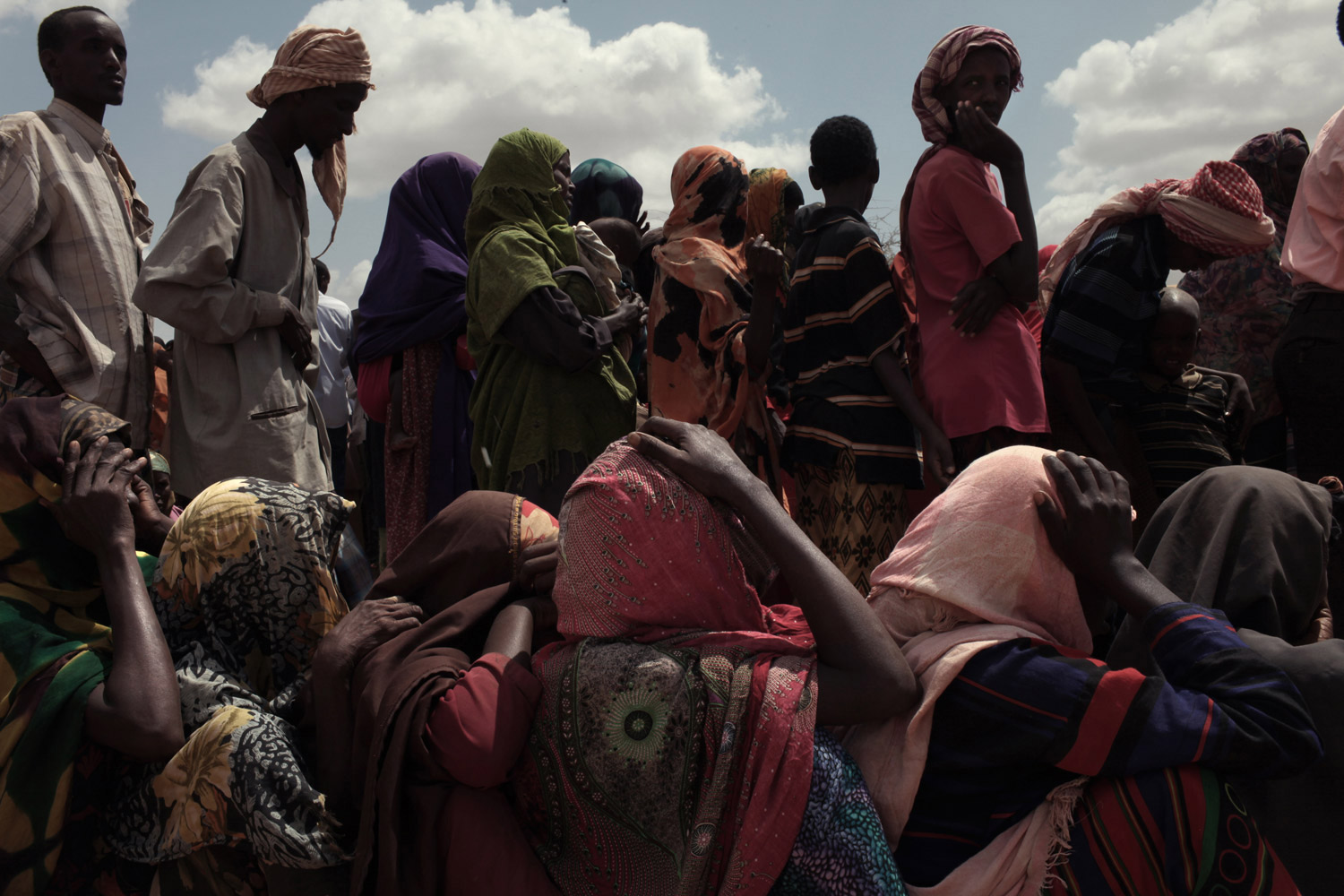 Jehad Nga. From  Haven and Hell.  August 8, 2011 issue.
                              
                              At a processing center in the Dadaab complex, newly arrived Somalis wait for some clothes, cooking pots and food.