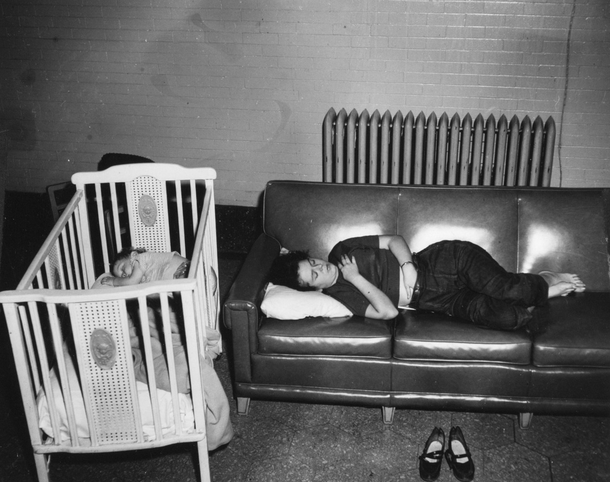 Woman and baby sleeping in lounge, Union Station, Denver, 1950