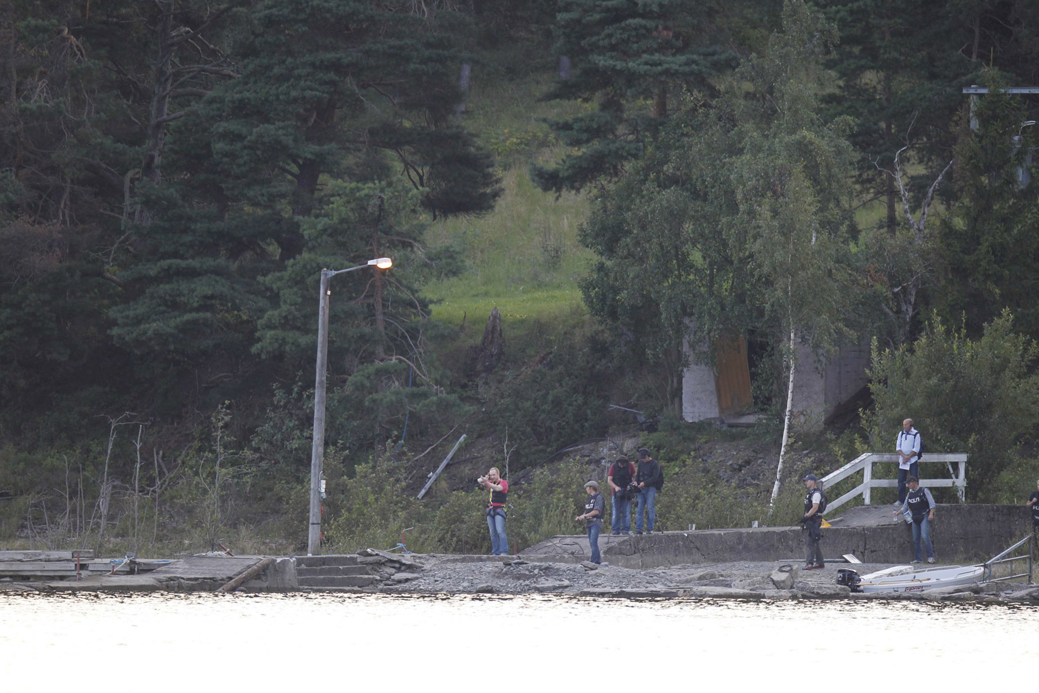 August 13, 2011. Under heavily armoured police guard, Anders Behring Breivik arrives back at Utoya for reconstruction of his terror actions on the island. Breivik (in red T-shirt) was tied with a rope.