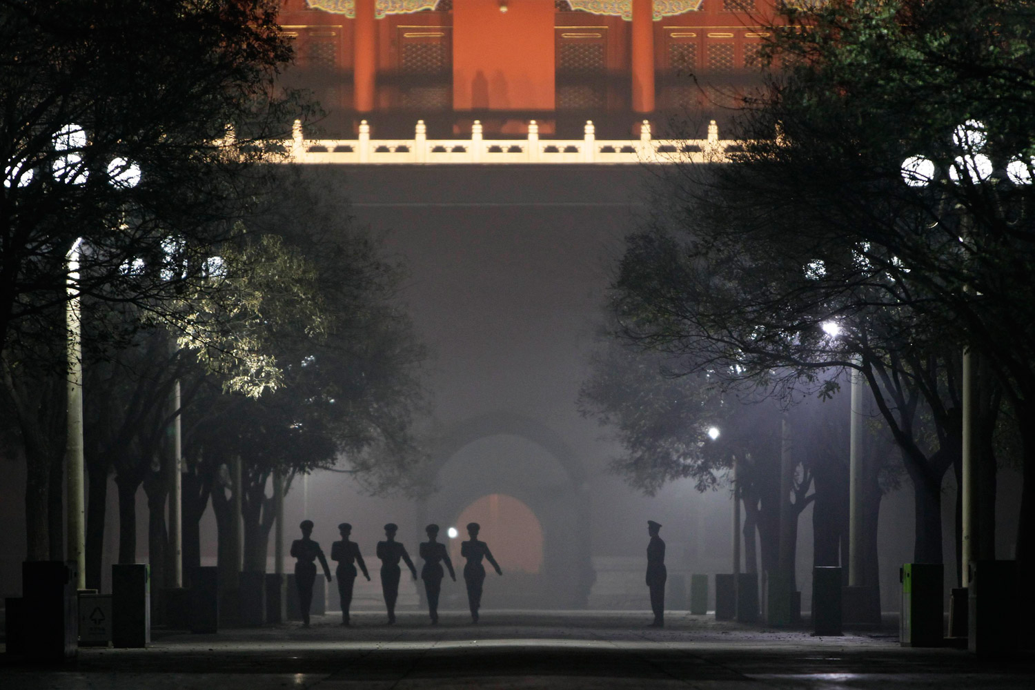 December 4, 2011. Paramilitary policemen practice drills inside the Forbidden City during a heavy haze and smog night in central Beijing, China.