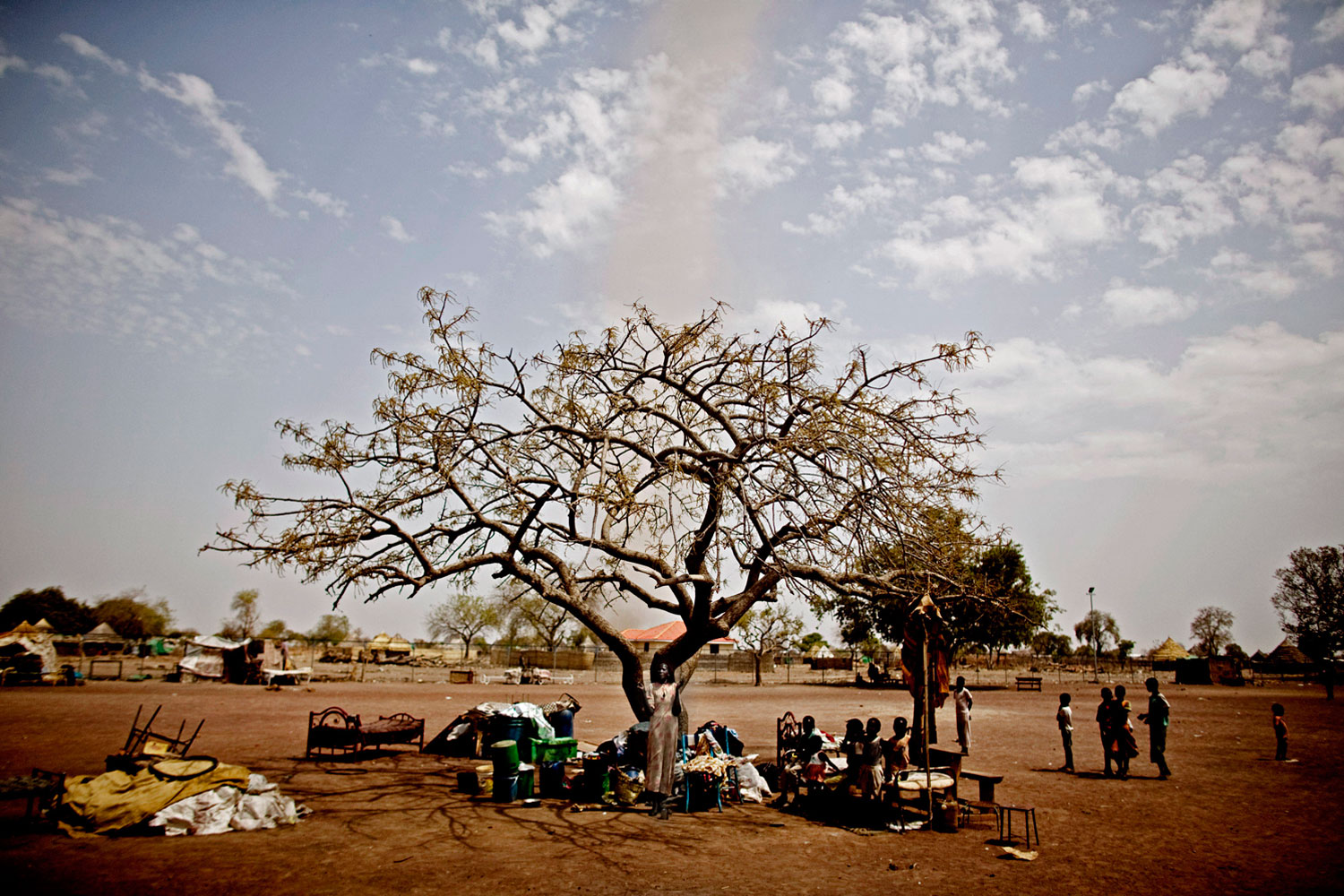 March 29, 2011. Southern Sudanese who returned from northern Sudan before the referendum live beneath a tree in the town of Kuajok. Hundreds of thousands of southerners living in the north returned between September and December 2010. Without land to return to, many remain stuck in transit camps where they wait for plot allocation from the southern government.