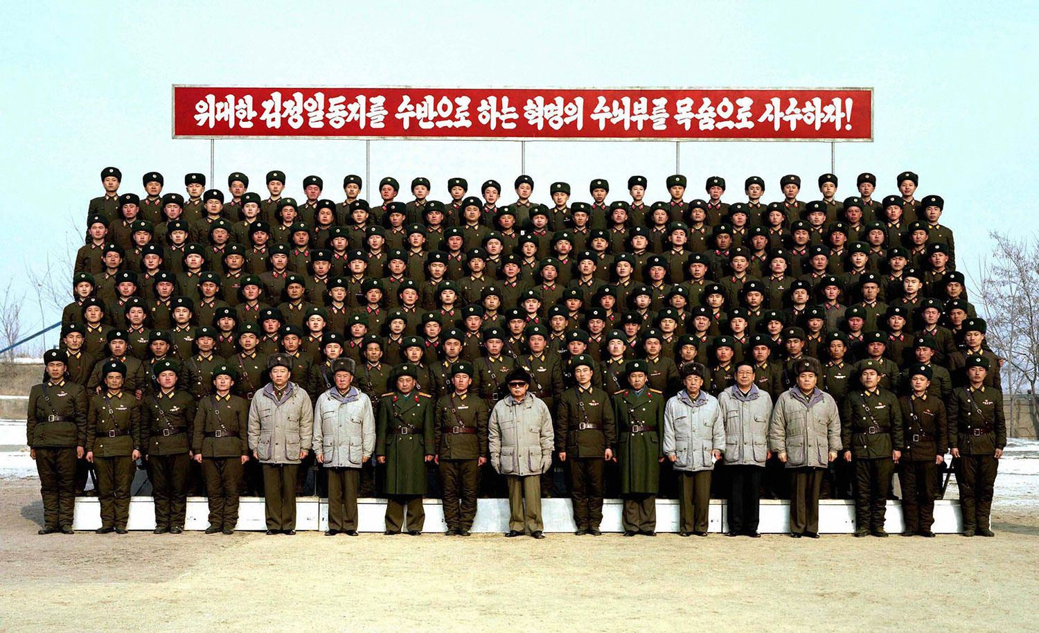 This undated picture, released by KCNA on Jan. 18, 2009, shows Kim Jong Il (center, in sunglasses) posing with soldiers as he inspects a sub-unit of a Korean People's Army Unit 2752 at undisclosed location.