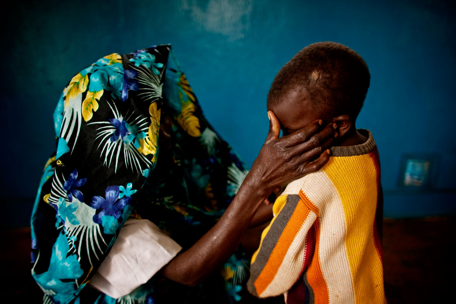 Portrait #7
                              February 21, 2011. A mass rape victim comforts her son in the town of Fizi, Congo. Her identity has been concealed for security reasons and because rape carries strong social stigma.