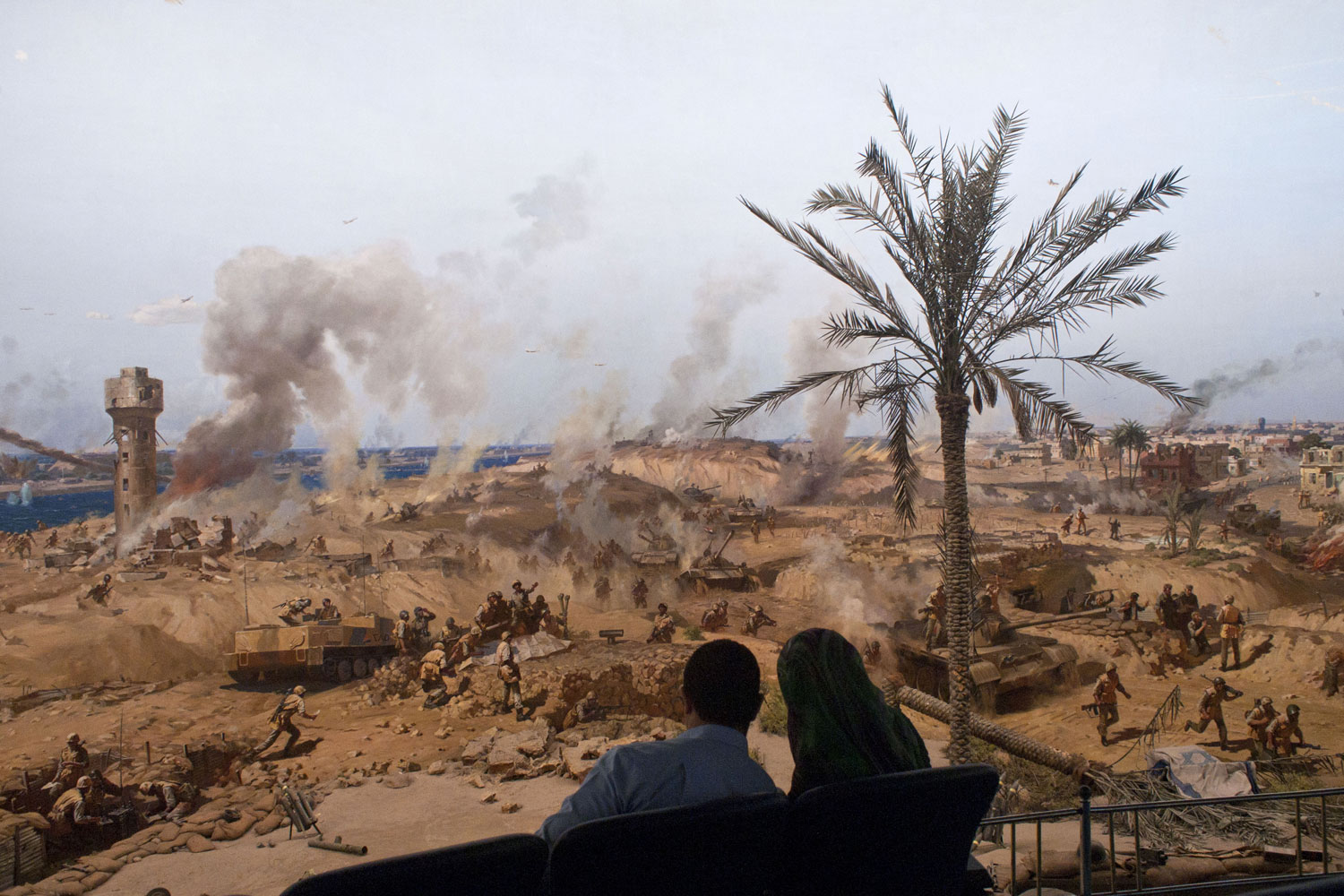 Thomas Dworzak. From  Egypt In Flux.  Published on LightBox, April 7 2011.
                              
                              A couple sits near a panorama in Cairo depicting Egypt's war with Israel, April 2, 2011.
