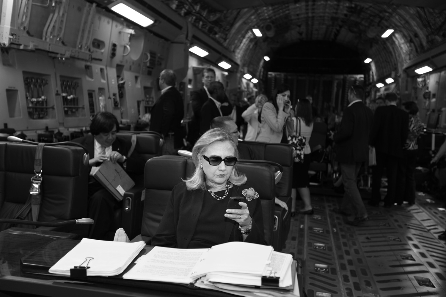 Diana Walker. From  Hillary Clinton; the Rise of Smart Power . November 7, 2011 issue (cover story).
                              Hillary Clinton checks her PDA in sunglasses upon departure in a military plane from Malta bound for Tripoli, on October 18, 2011.