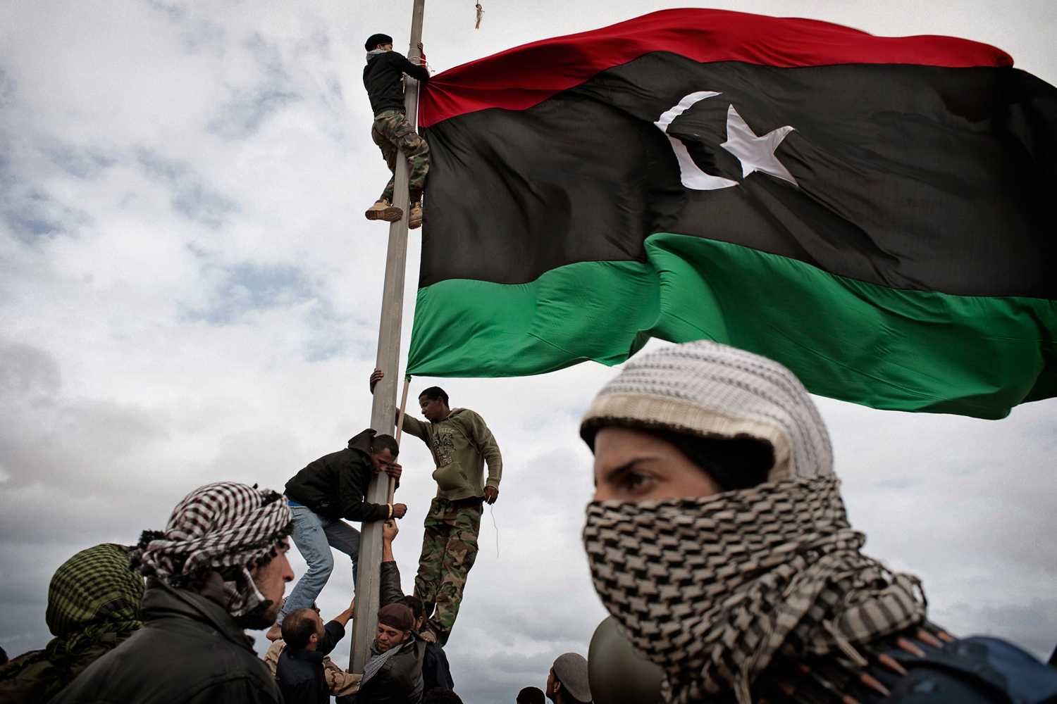 Ras Lanuf, Libya — March 8, 2011
                              Libyan rebels raise their flag at a checkpoint that they had seized a few days earlier.