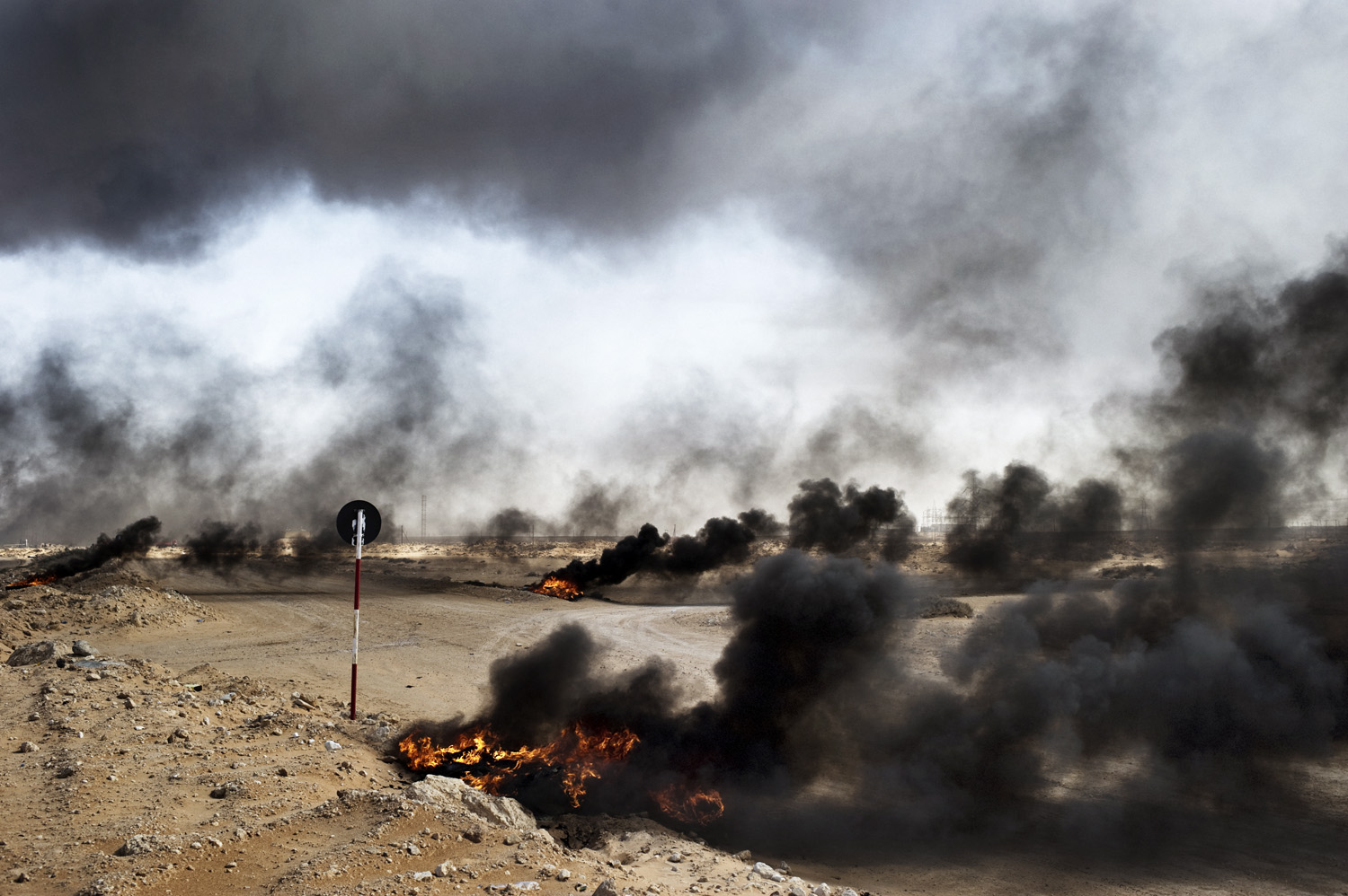 Yuri Kozyrev. From  Why Are We in Libya?  April 4, 2011 issue.
                              In Ras Lanuf rebels leave pockets of fire as they advance during a battle with government troops.