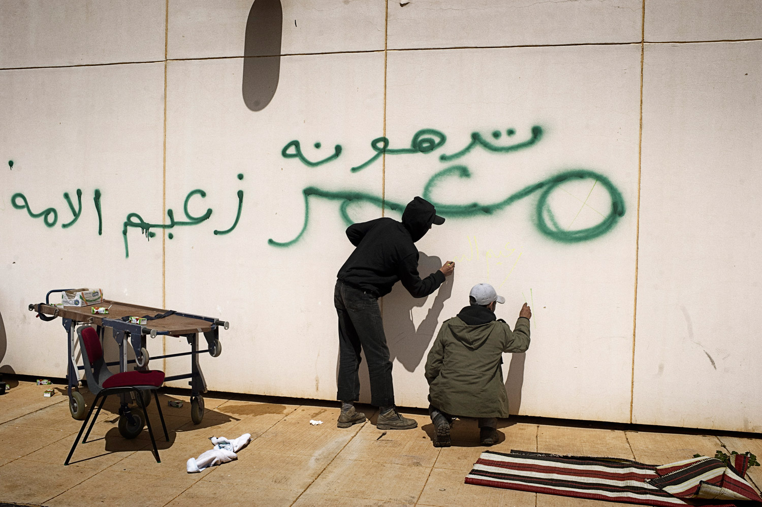 Yuri Kozyrev. From  Table of Contents.  April 11, 2011 issue.
                              
                              Libyan rebels scrawl graffiti on a wall near a hospital in Ras Lanuf on March 27, 2011. The wall was previously defaced, in green, by Gaddafi troops.