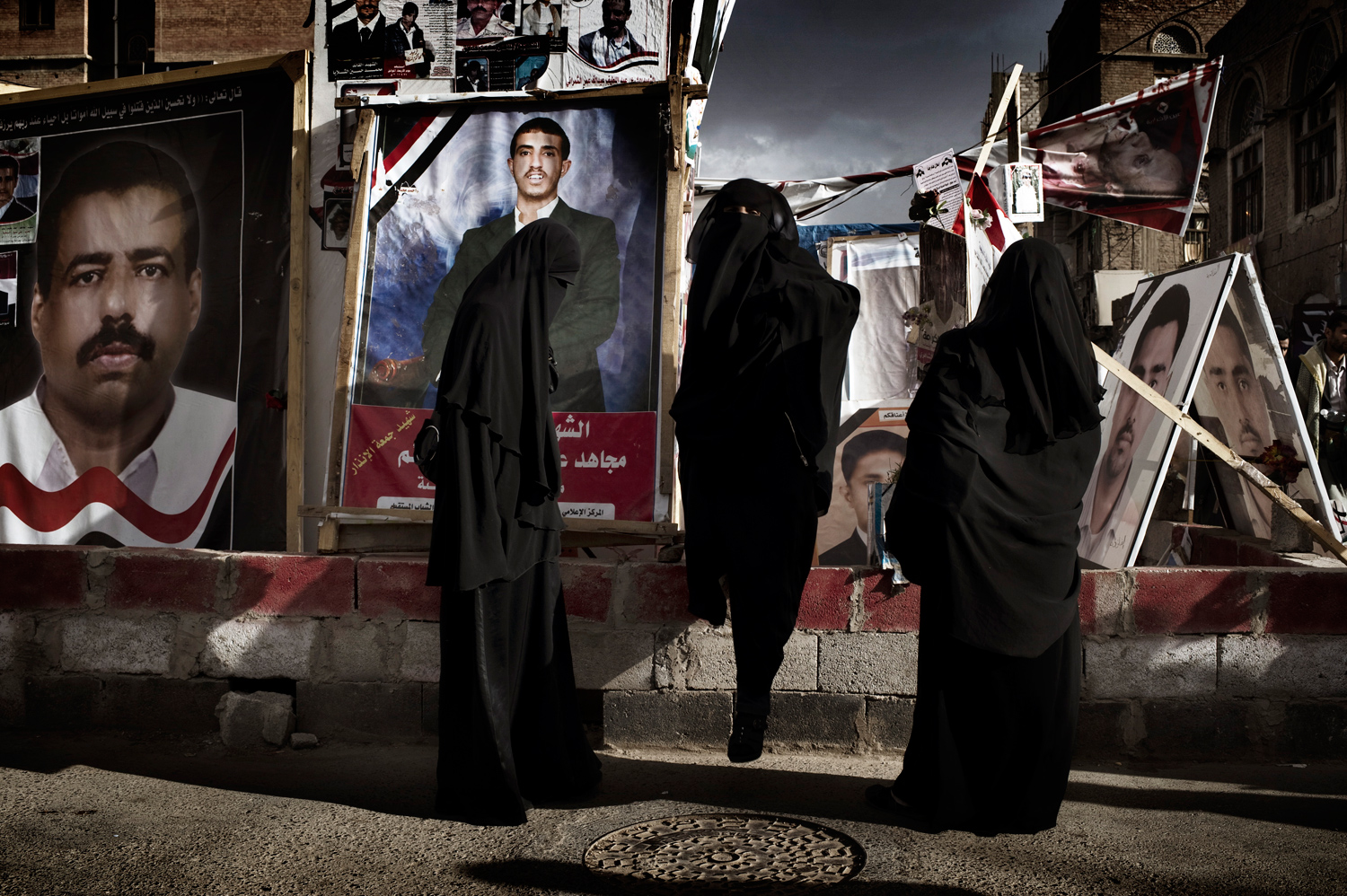 Sana'a, Yemen — May 17, 2011
                              Women visit a shrine to fallen protesters in the tent city outside of the university.