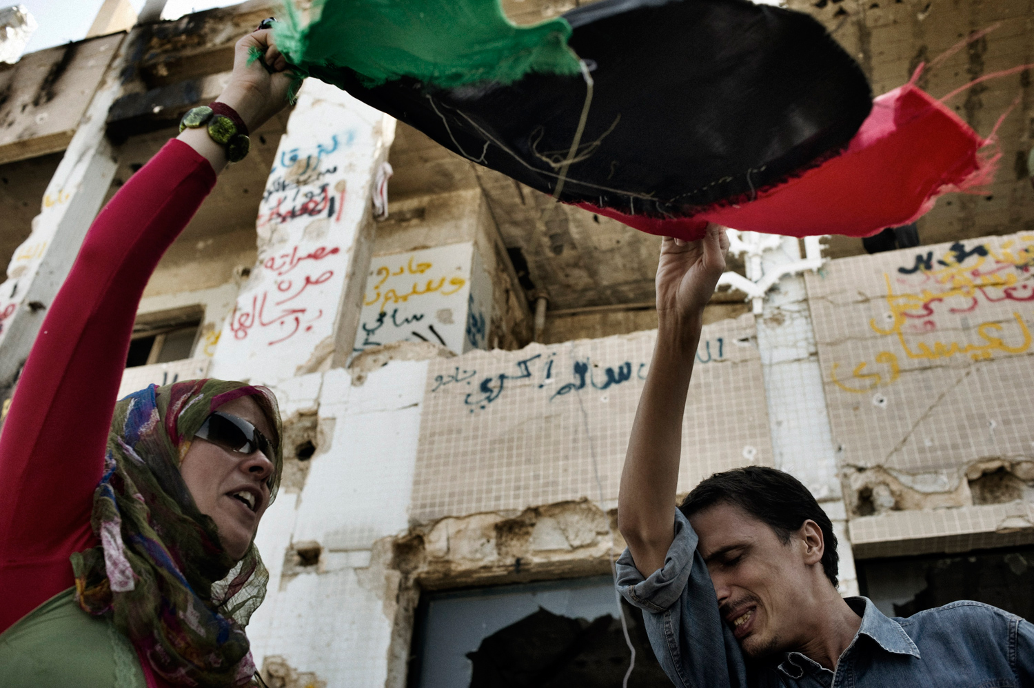 Tripoli, Libya — August 29, 2011
                              Libyans celebrate at the Bab Al-Aziziya compound.