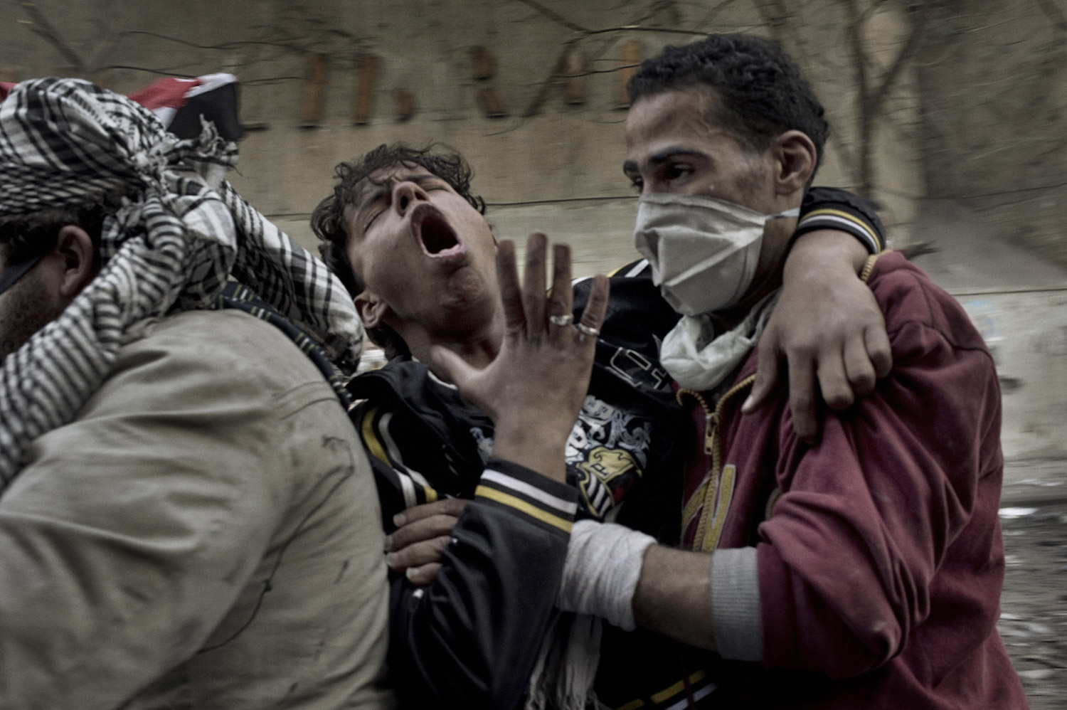 A protester overcome by tear gas is evacuated from Mohamed Mahmoud street, November 23, 2011.