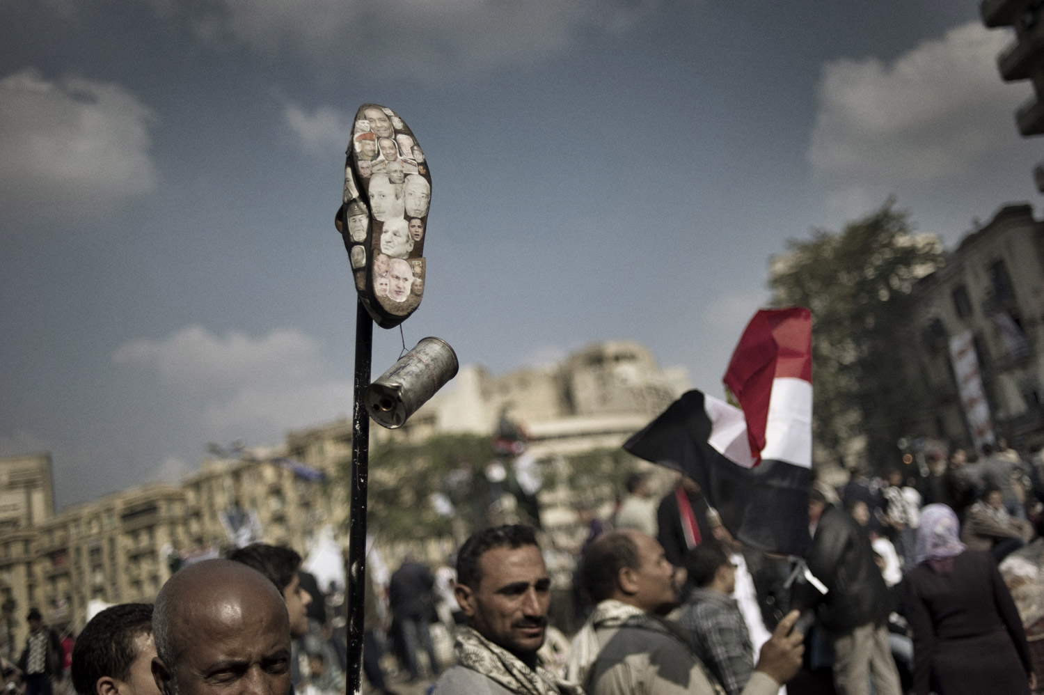 Photographs of politicians are plastered on the sole of a shoe during continued protests in Tahrir Square, November 25, 2011.