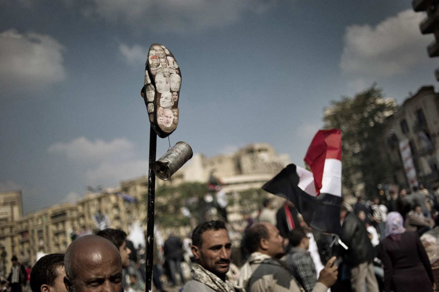 Cairo, Egypt — November 25, 2011
                              Photographs of politicians are plastered on the sole of a shoe, a sign of disrespect, during continued protests in Tahrir Square.