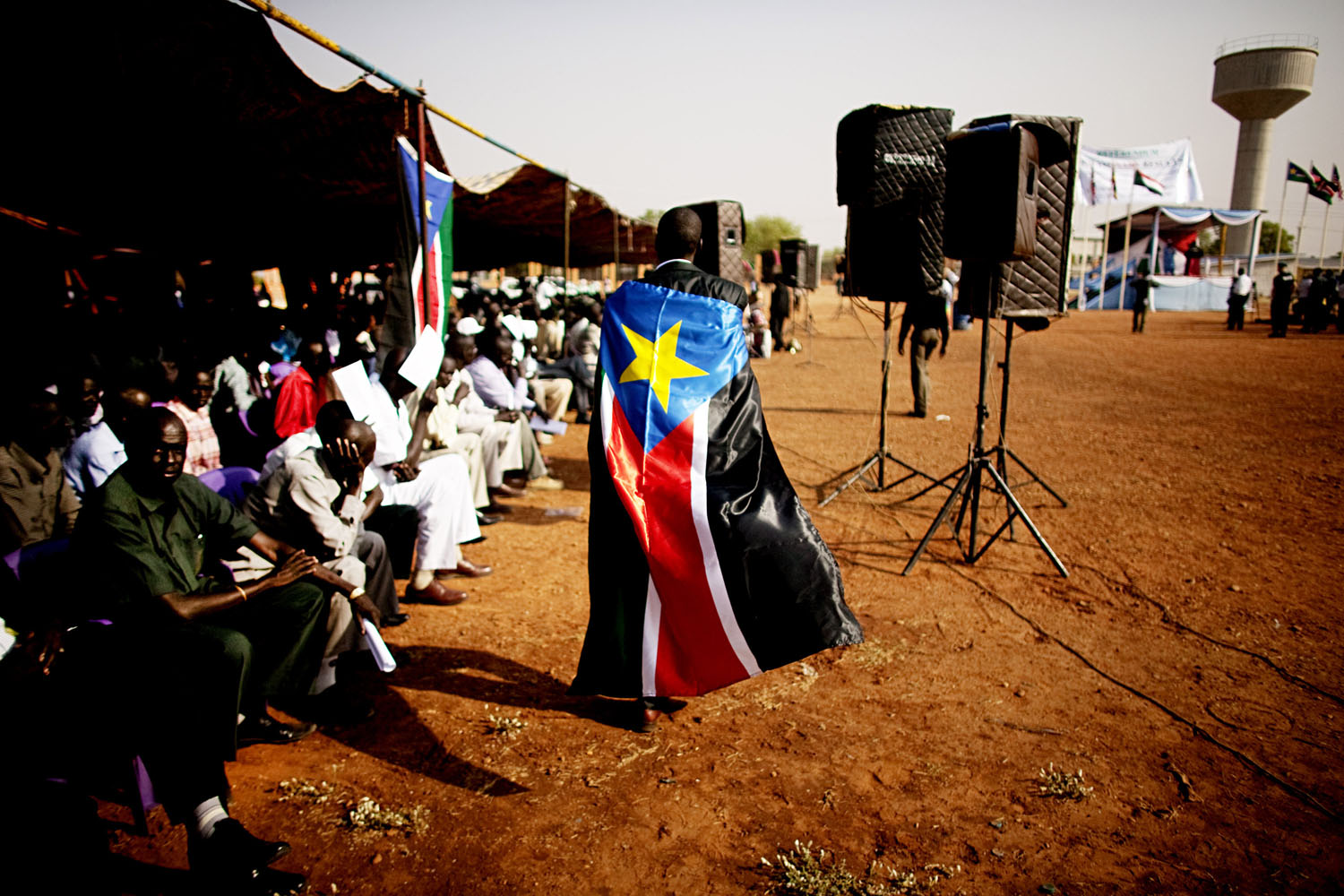 January 30, 2011. A man dons the flag of the Sudan People's Liberation Movement during a rally in Juba.