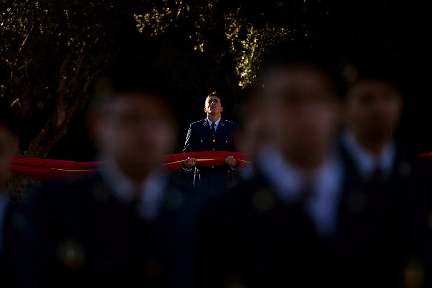 December 6,2011. A Spanish officer participates in the raising ceremony of the Spanish national flag during the celebrations of the 33rd anniversary of the Spanish Constitution, in Madrid.
