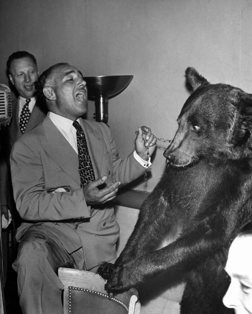 Stanley Beebe sings to an evidently alarmed Rosie the bear, 1946.