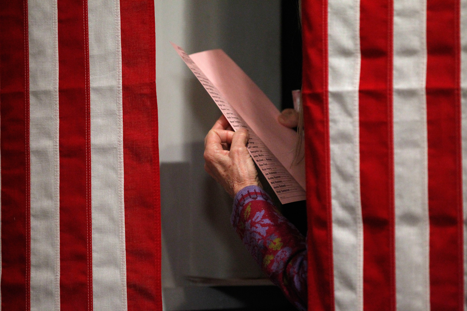 January 9, 2012. A resident reads over her ball ballots before the stroke of midnight when she can cast her vote in the first-in-the-nation presidential primary, at The Balsams Grand Resort, Monday in Dixville, N.H.