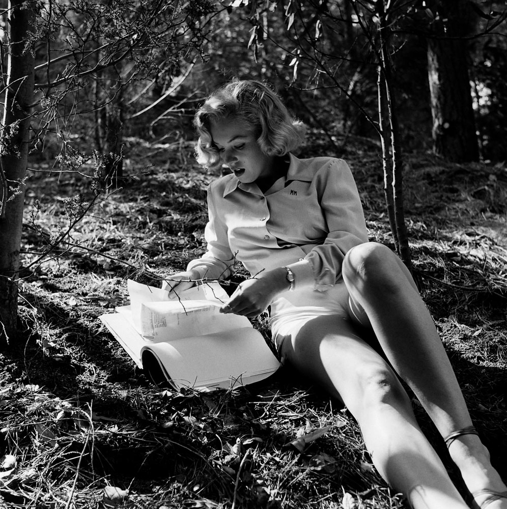 Marilyn Monroe reads a script in a park in Los Angeles.