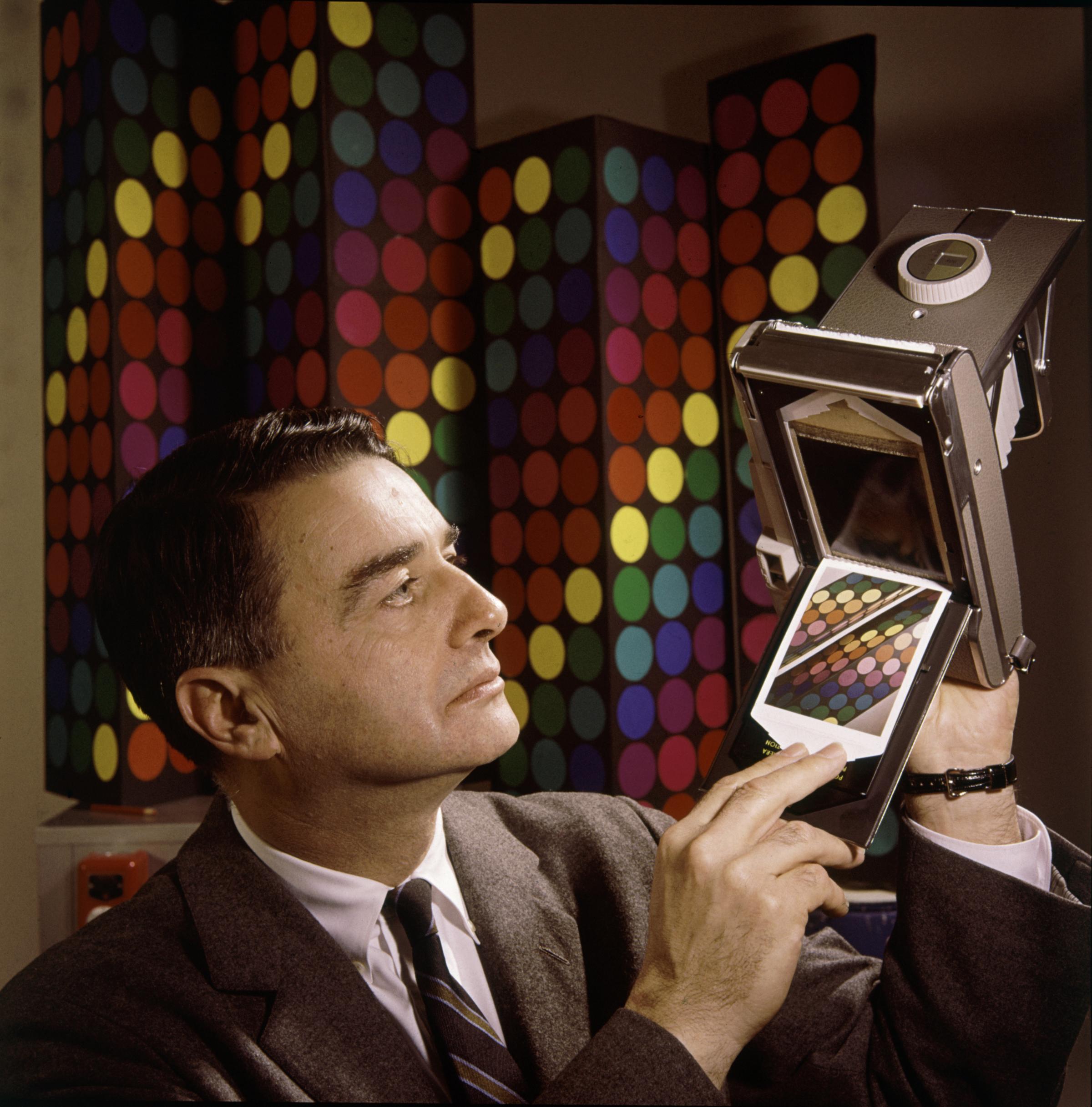 Edwin Land, the president and co-founder of the Polaroid Corporation, demonstrates his company's "60-second film" in 1963.