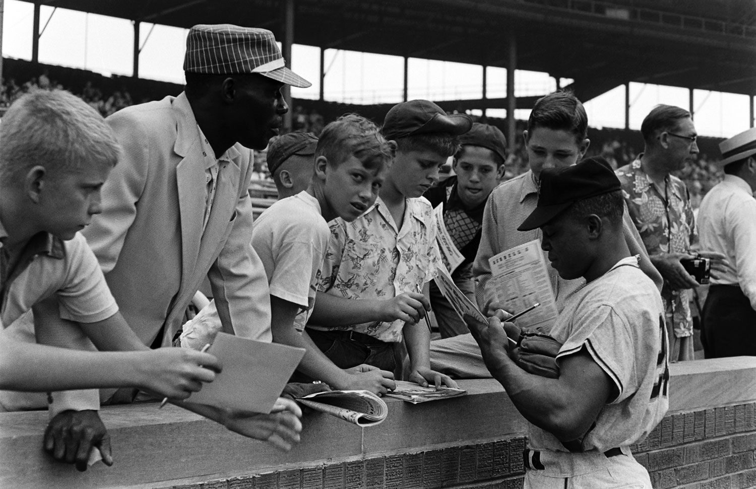 Willie Mays signs autographs for fans, 1954.