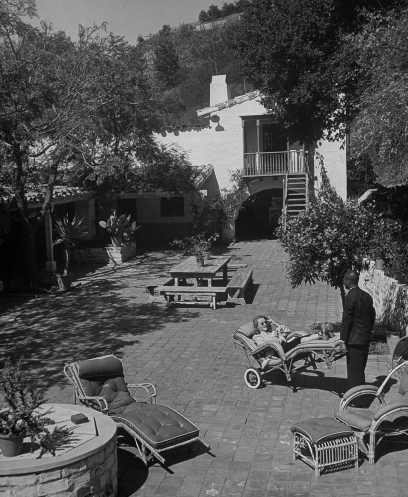 Bette Davis' Chauffeur Wheels Her Around in the Backyard in Beverly Hills in 1939.