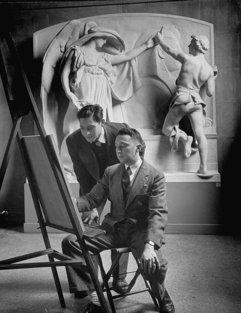 Standing behind an easel, two art students copy work at the Metropolitan Museum of Art in New York.