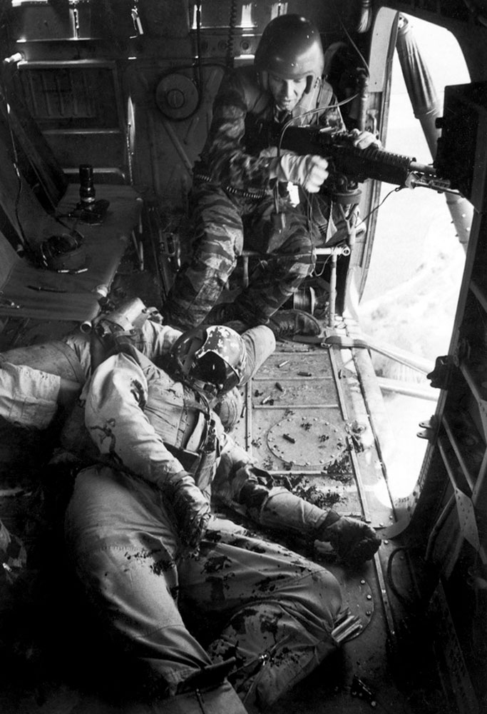 Caption from LIFE.  Farley, unable to leave his gun position until YP13 is out of enemy range, stares in shock at YP3's co-pilot, Lieutenant Magel, on the floor.