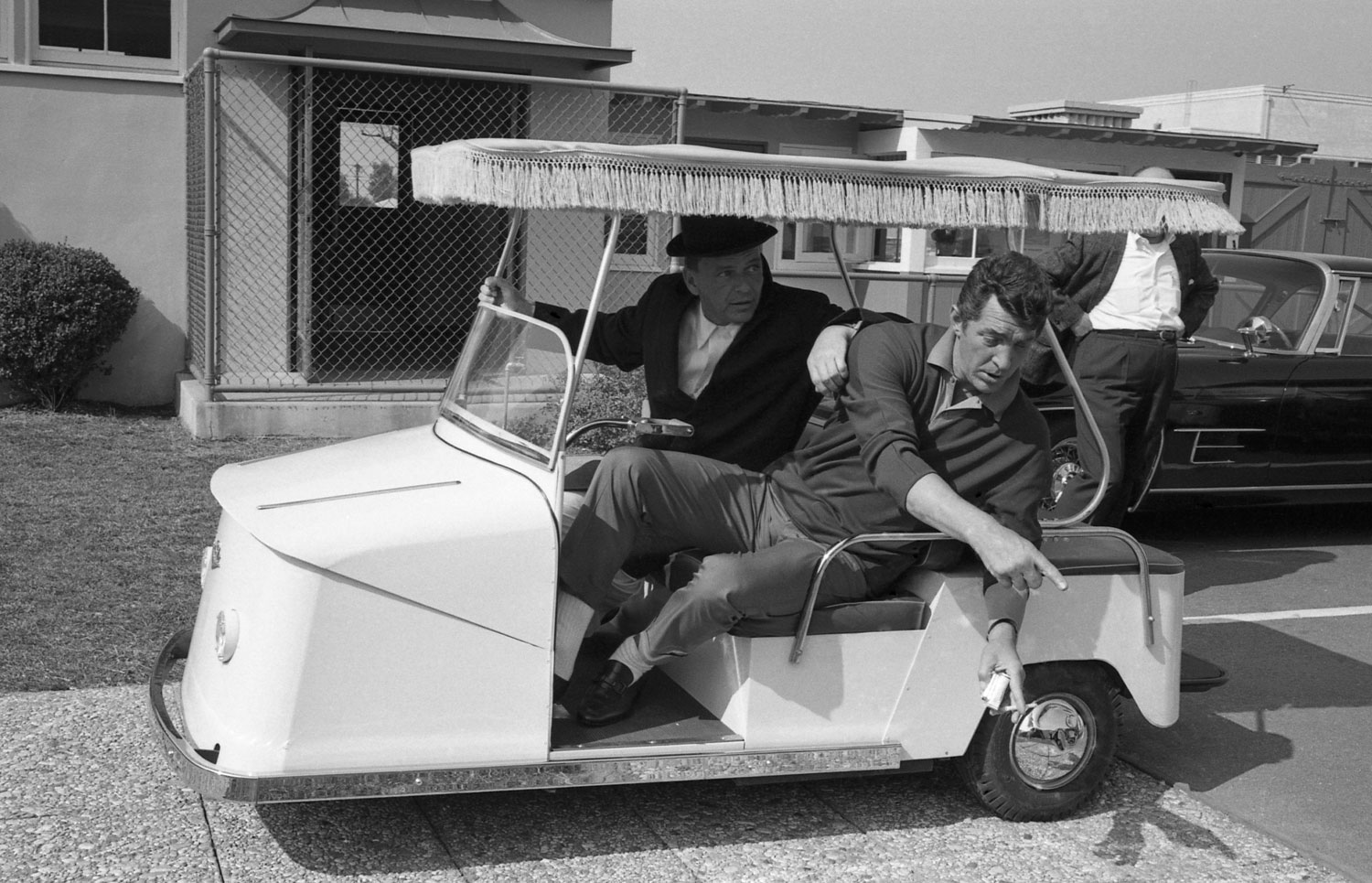 Frank Sinatra and Dean Martin drive a golf cart at Warner Bros. Studio in 1965 while making Marriage on the Rocks.