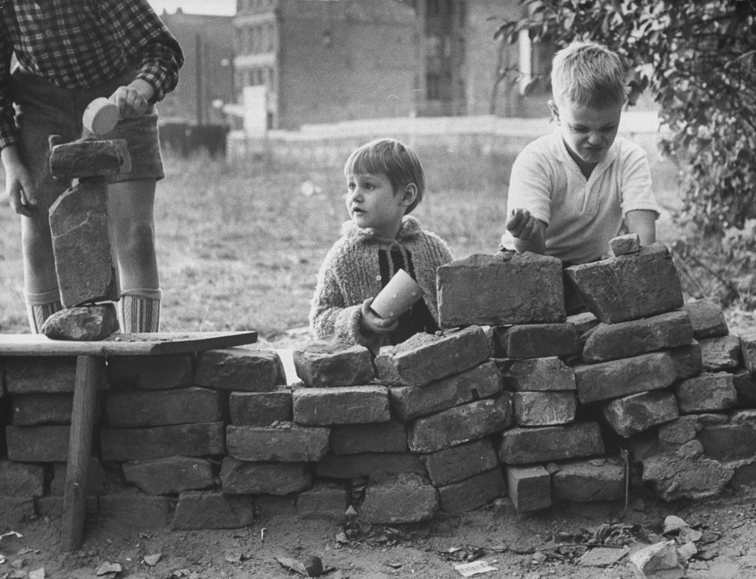 West Berlin children build a pretend Berlin Wall
