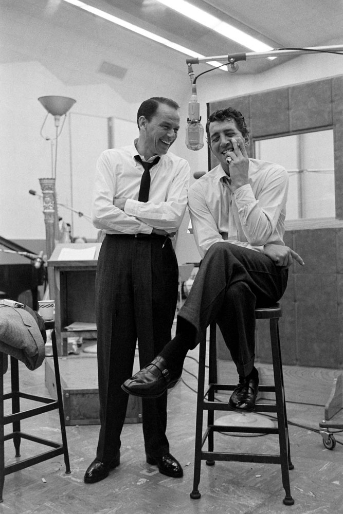 Frank Sinatra and Dean Martinshare a light moment in the recording studio in 1958.