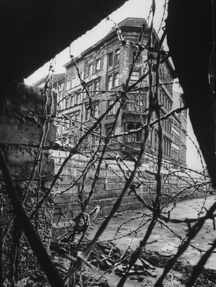 Berlin is seen through barbed wire and rubble
