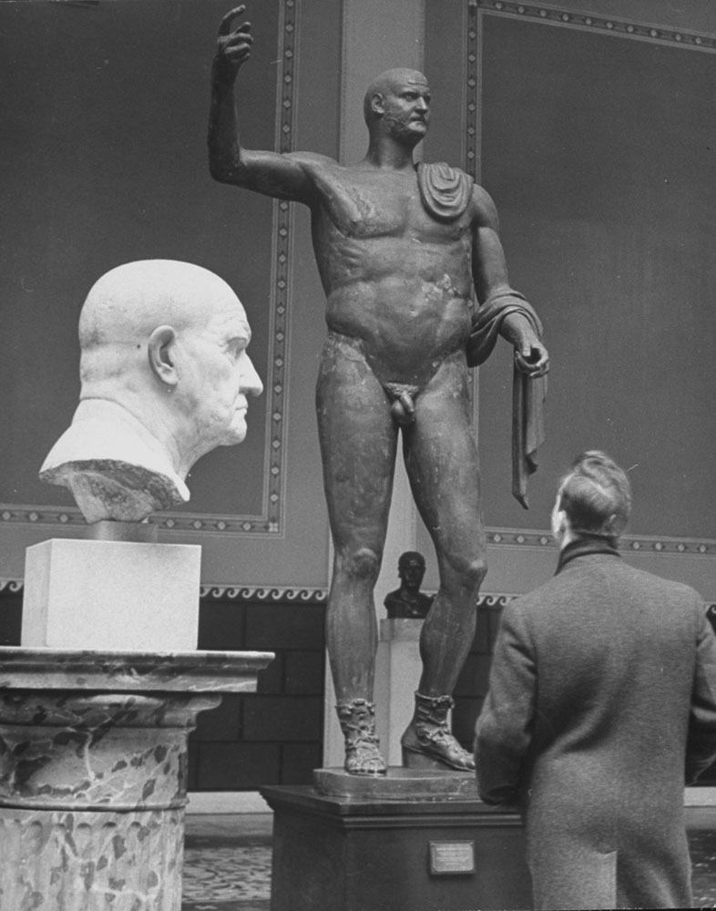 A visitor takes in Roman sculpture at the Metropolitan Museum of Art in New York, January 1939.