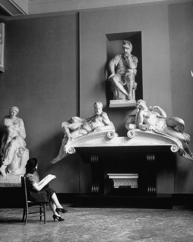 A seated female student studies statues in a sculpture gallery at the Metropolitan Museum of Art.