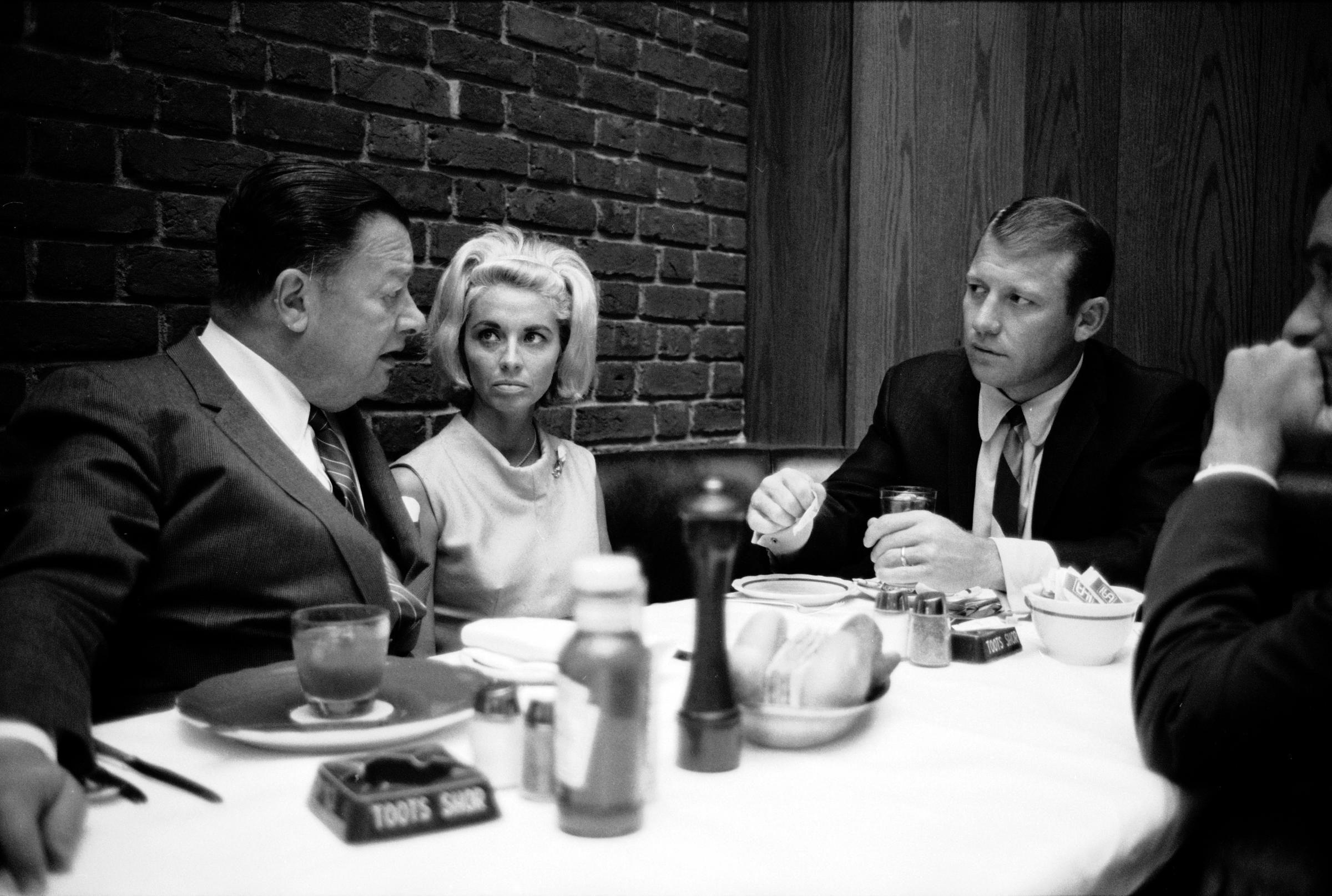 Left to right, self-described "saloon keeper" Bernard "Toots" Shor talks with Merlyn Mantle and husband Mickey at Shor's restaurant, New York, NY, June 1965.