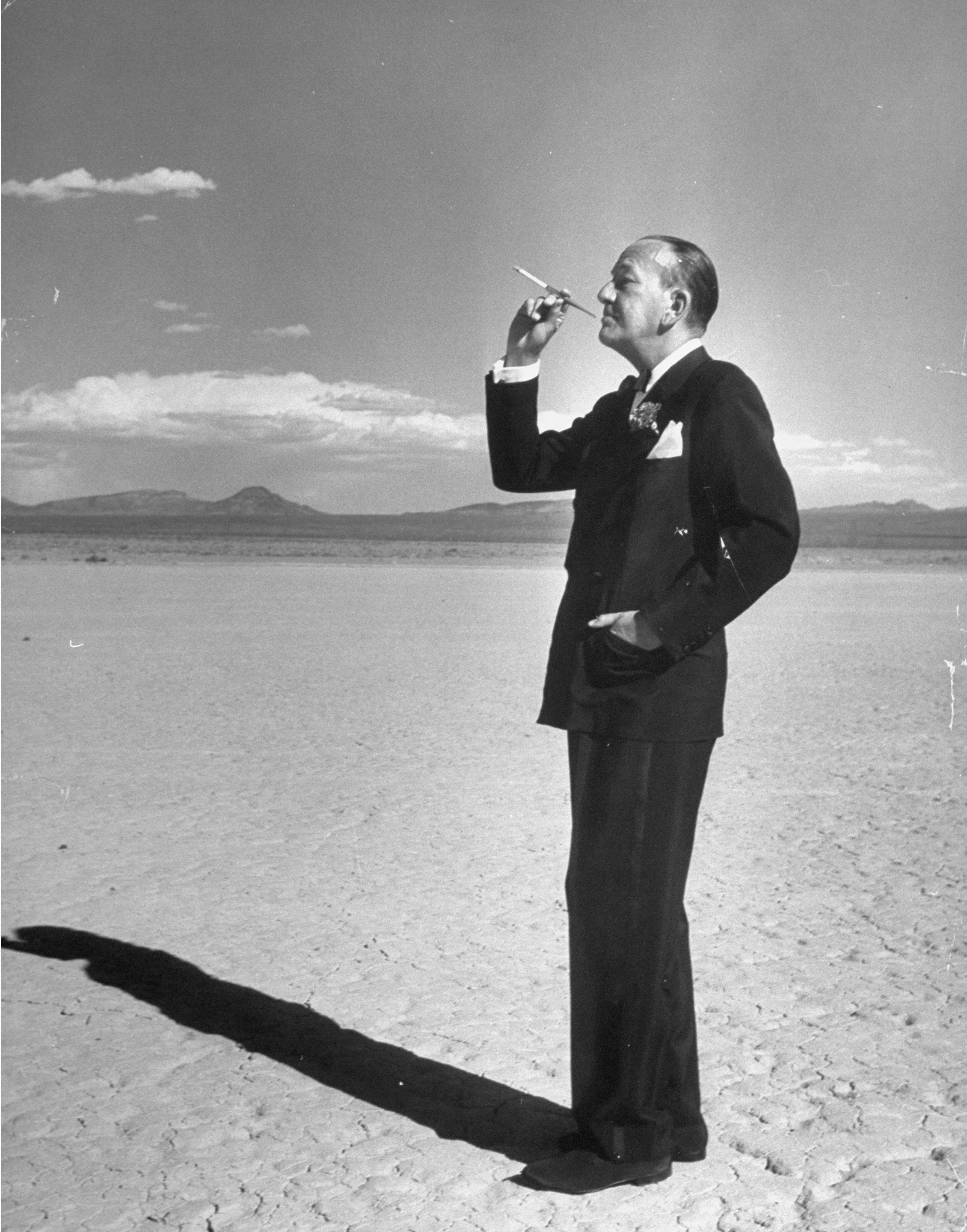 The playwright and composer Noel Coward poses in the desert outside Las Vegas, 1955.