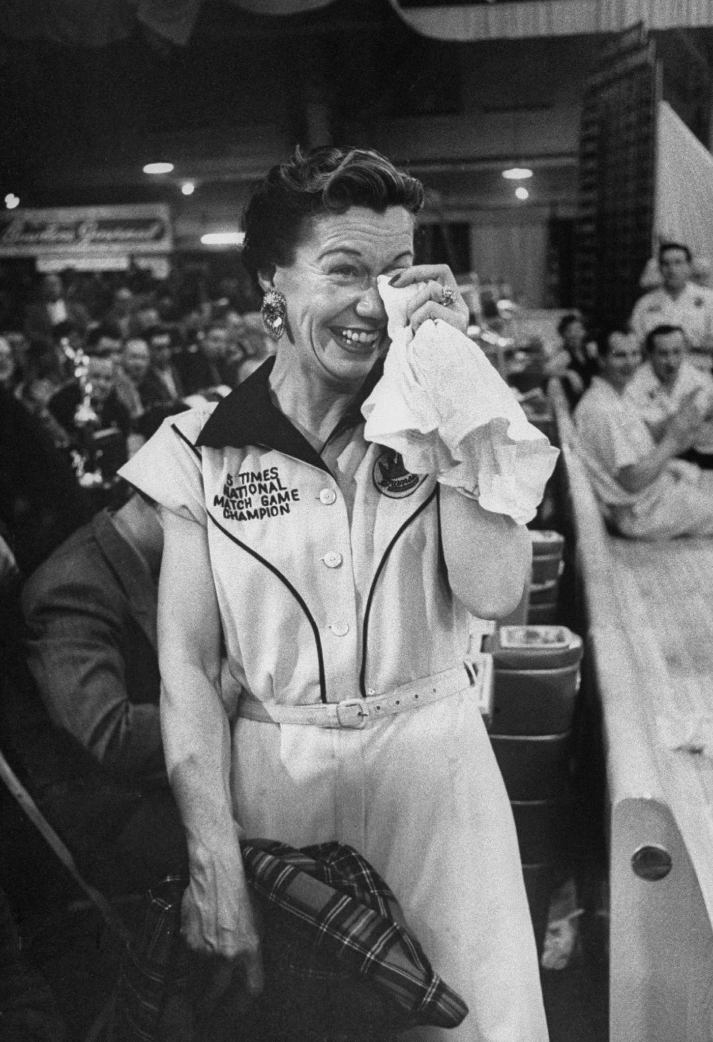 Marion Ladewig, the "Queen of Bowling," dabs at her eyes after losing a championship tournament.