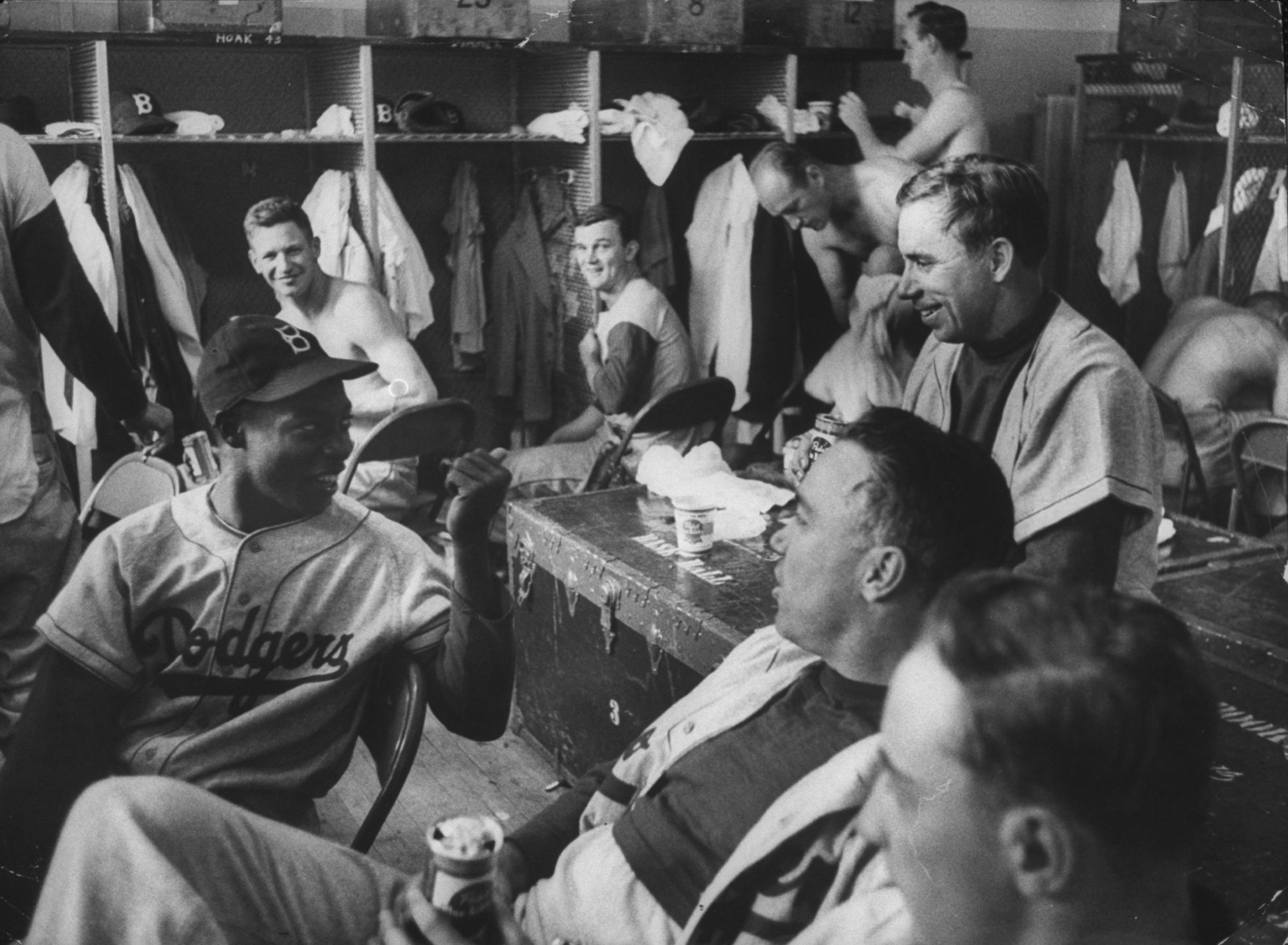 Sandy Amoros (with cap), Pee Wee Reese (on trunk), and Duke Snider (with beer) joke around after a game, May 13, 1955.