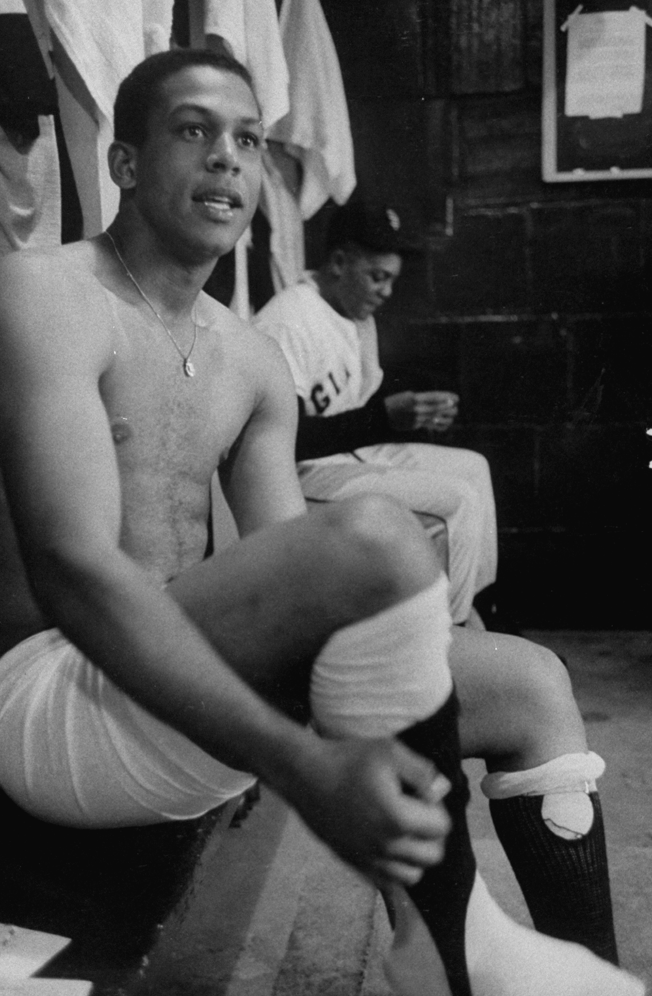 Orlando Cepeda gets dressed in the locker room in June, 1958.